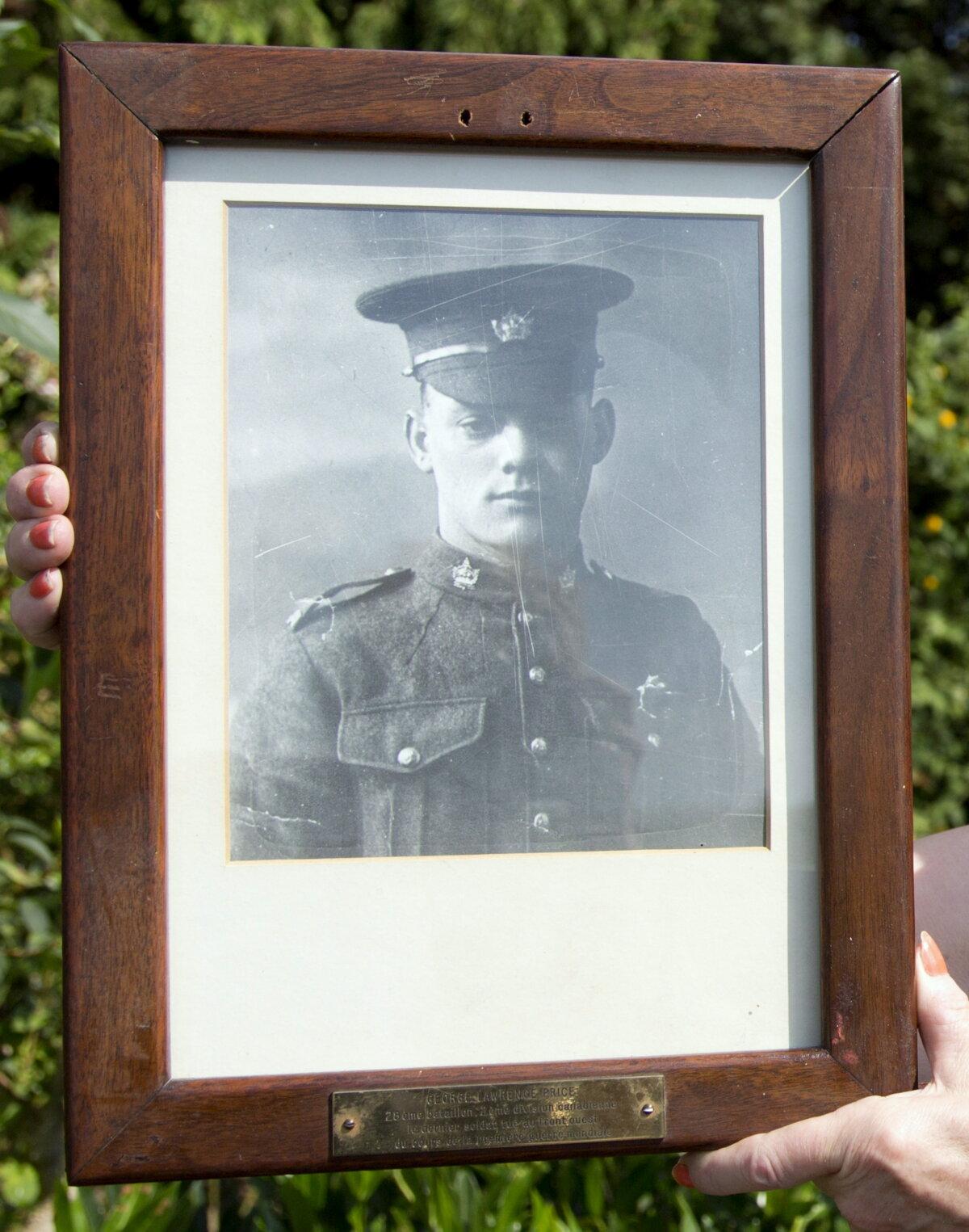 A photo of Canadian soldier Pte. George Price is shown in the Belgian village of Ville-sur-Haine on Aug. 3, 2014, the day before a ceremony to commemorate 100 years since the start of World War I. (AP Photo/Virginia Mayo)