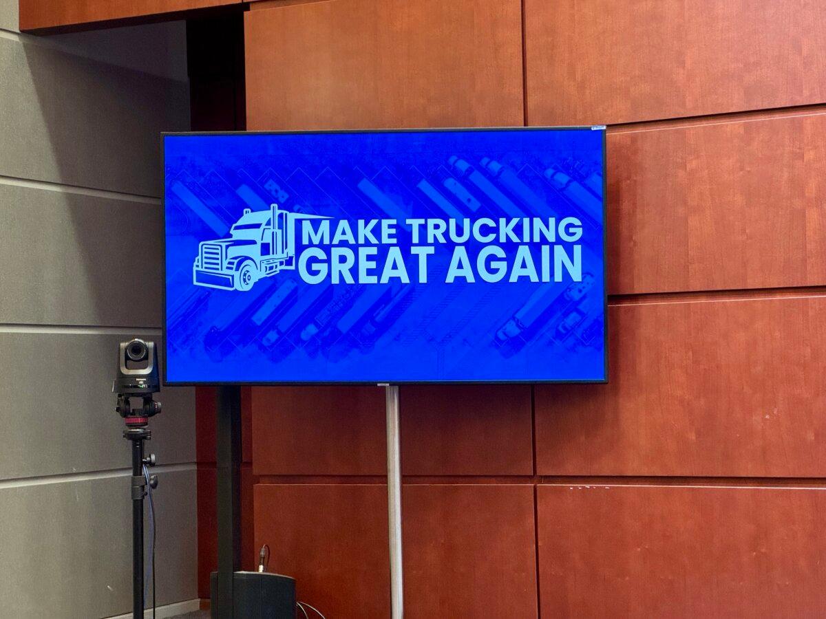 A sign at a press conference held by U.S. Secretary of Transportation Sean Duffy at the Department of Transportation's headquarters in Washington on Oct. 30, 2025. (Arjun Singh/The Epoch Times)
