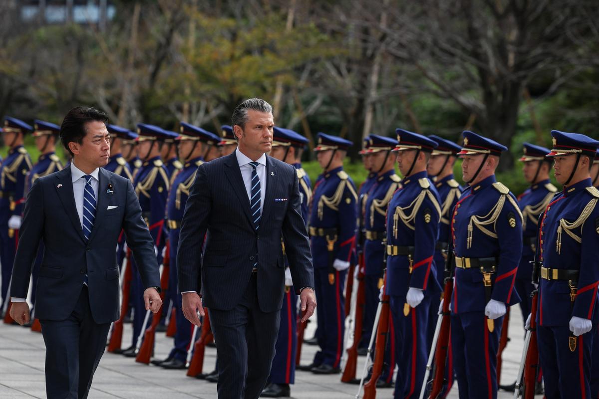 Japanese Minister of Defense Shinjiro Koizumi (L) and U.S. Secretary of War Pete Hegseth (R) inspect an honor guard before their meeting at the Japanese defense ministry in Tokyo, Japan, on Oct. 29, 2025. (Takashi Aoyama/Pool/AFP via Getty Images)