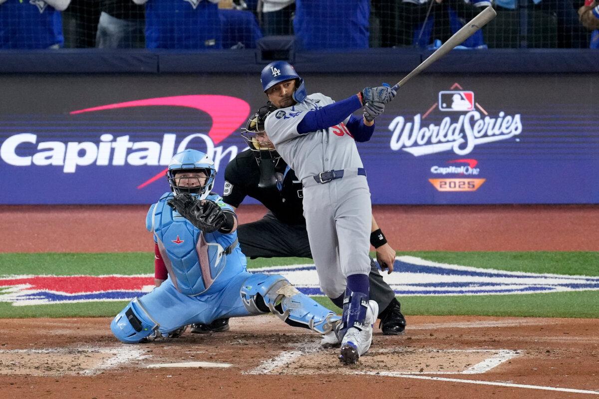 Los Angeles Dodgers' Mookie Betts follows through on his two run base hit against the Toronto Blue Jays during the third inning in Game 6 of MLB's World Series in Toronto on Oct. 31, 2025. (AP Photo/Ashley Landis)
