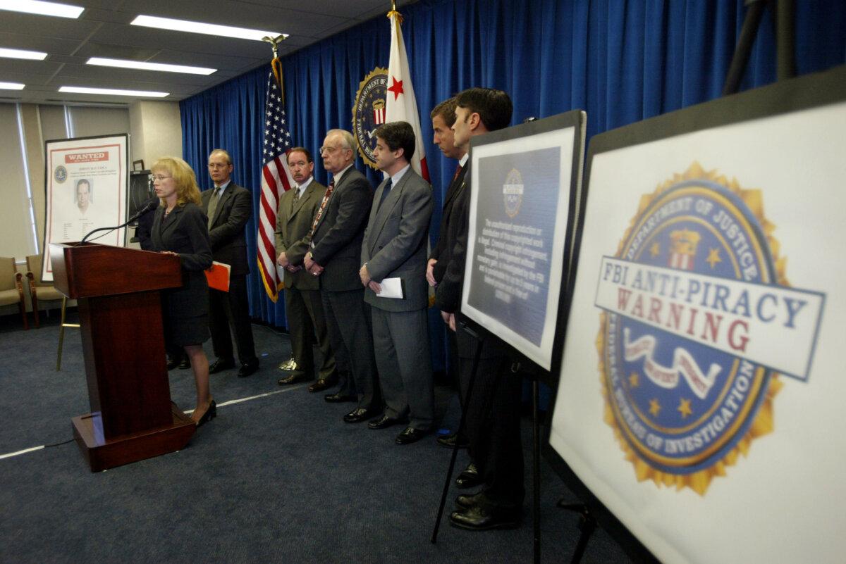 FBI Cyber Division Assistant Director Jana Monroe speaks near a large warning label at a news conference in Los Angeles on Feb. 16, 2004. (David McNew/Getty Images)