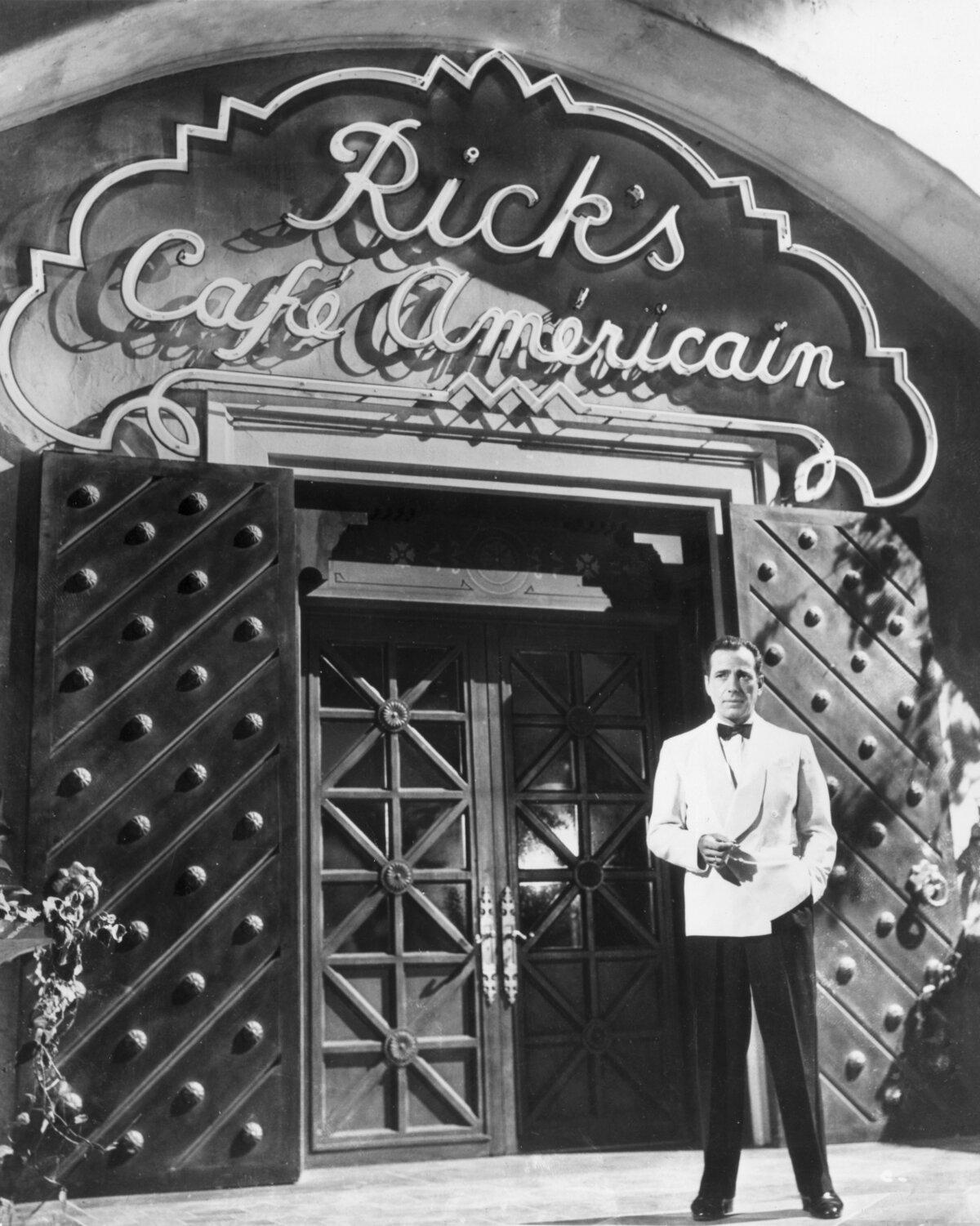 Humphrey Bogart stands outside the movie set in promotional photo for "Casablanca." (Warner Bros./MovieStillsDB)