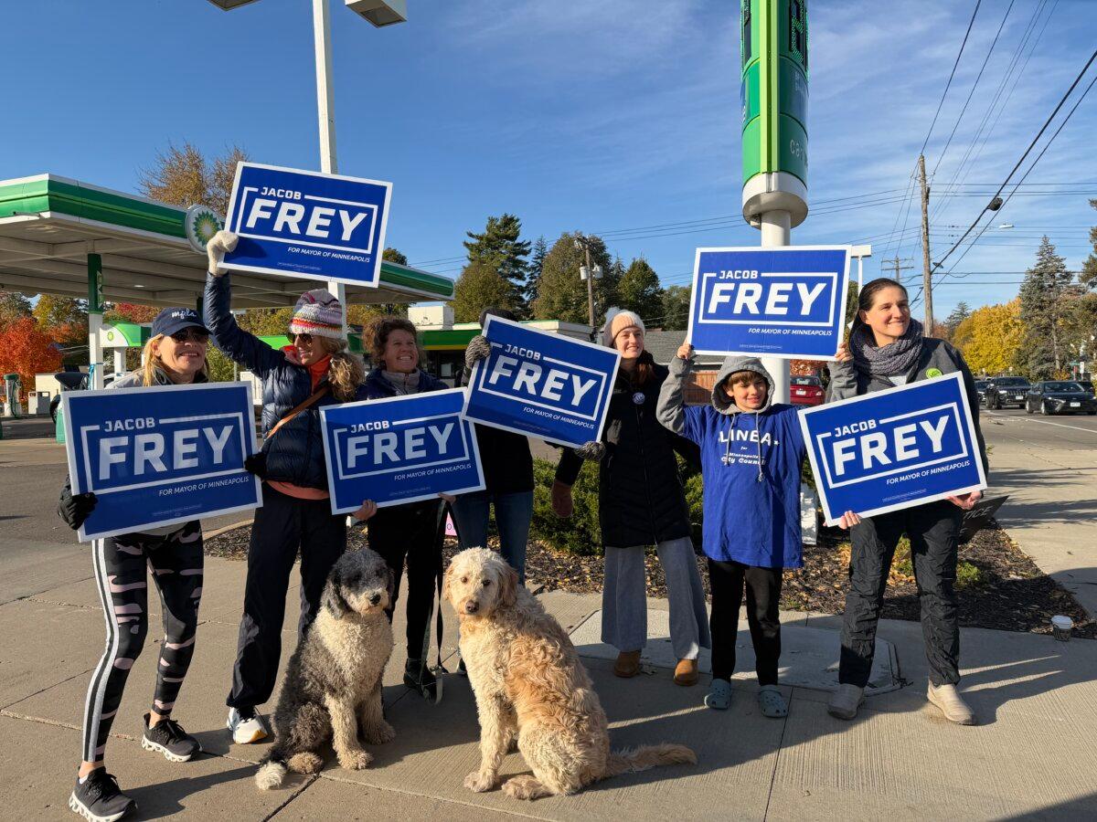 Supporters of Minneapolis Mayor Jacob Frey hold signs near a polling venue in the city's southwest on Nov. 4, 2025. (Janice Hisle/The Epoch Times)