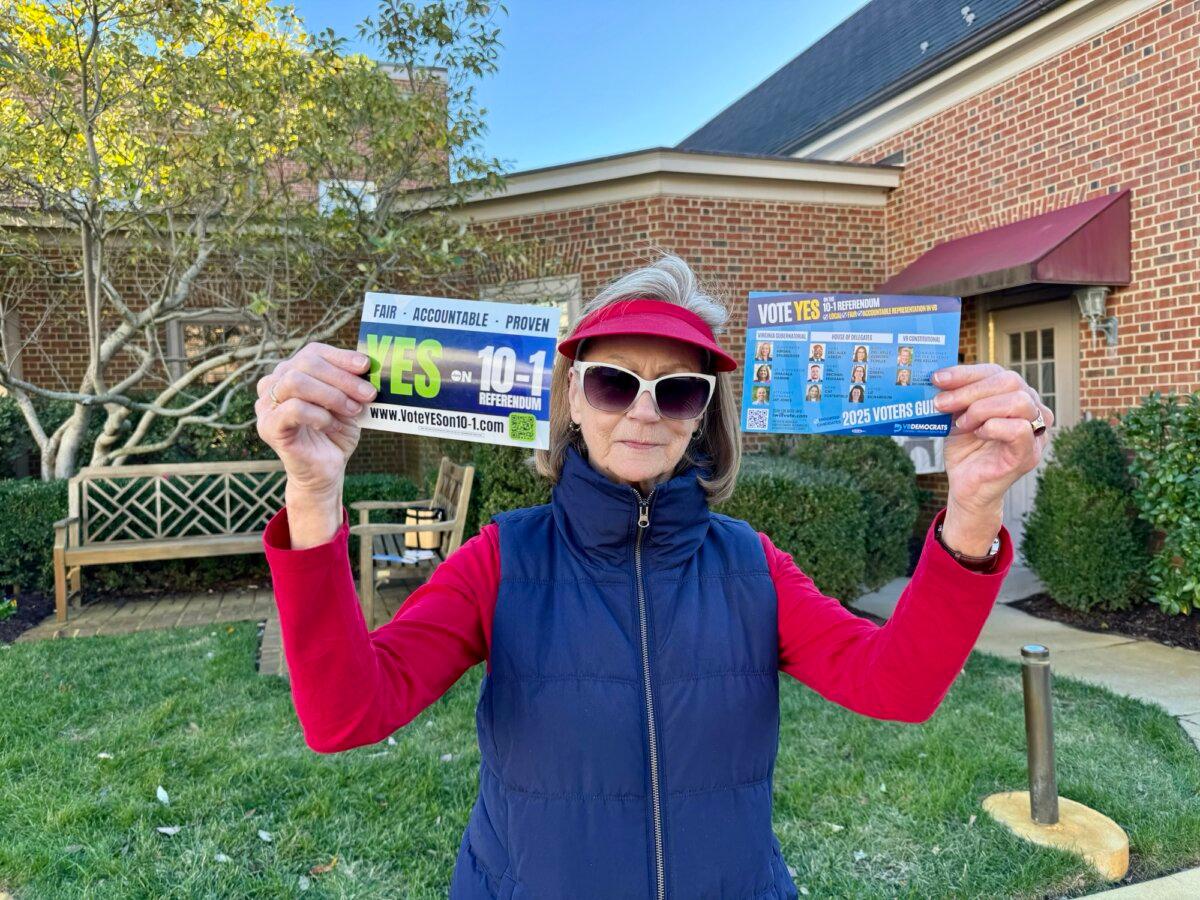 Nancy Brown, a volunteer for the Democratic Party, holds up flyers she distributed to voters on Election Day during Virginia's 2025 general election, in Virginia Beach, Va., on Nov. 4, 2025 (Arjun Singh/The Epoch Times).