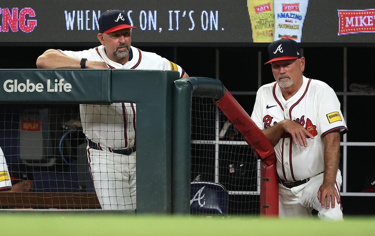 Manager Brian Snitker (R) and bench coach Walt Weiss of the Atlanta Braves converse during the seventh inning against the San Francisco Giants at Truist Park in Atlanta, Georgia on July 22, 2025. (Kevin C. Cox/Getty Images)