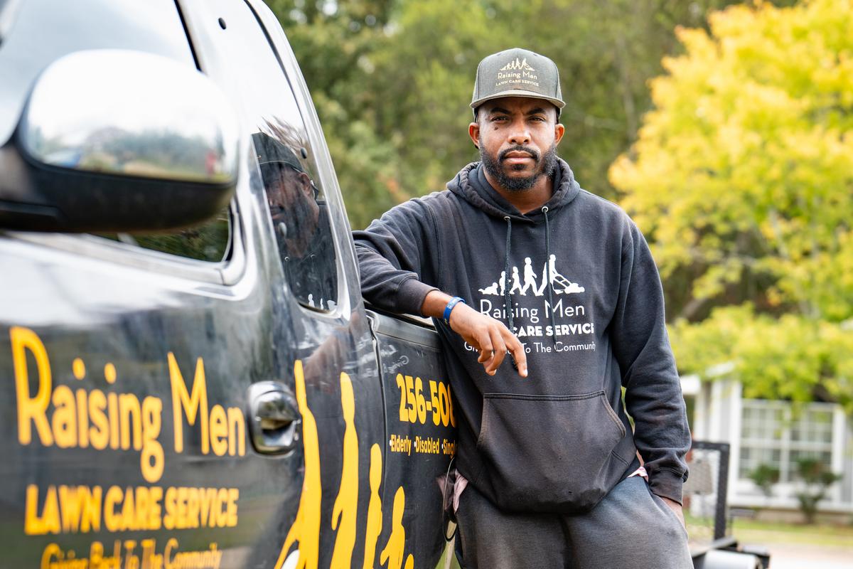 Rodney Smith Jr., founder of Raising Men and Women Lawn Care Service, in front of his truck in Madison, Ala., on Oct. 28, 2025. (Samira Bouaou/The Epoch Times)