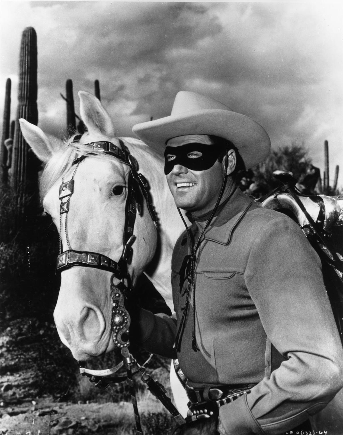 A promotional portrait for the television series “The Lone Ranger” starring Clayton Moore as the Lone Ranger and his horse, Silver, circa 1955. (Halas & Batchelor/Getty Images)