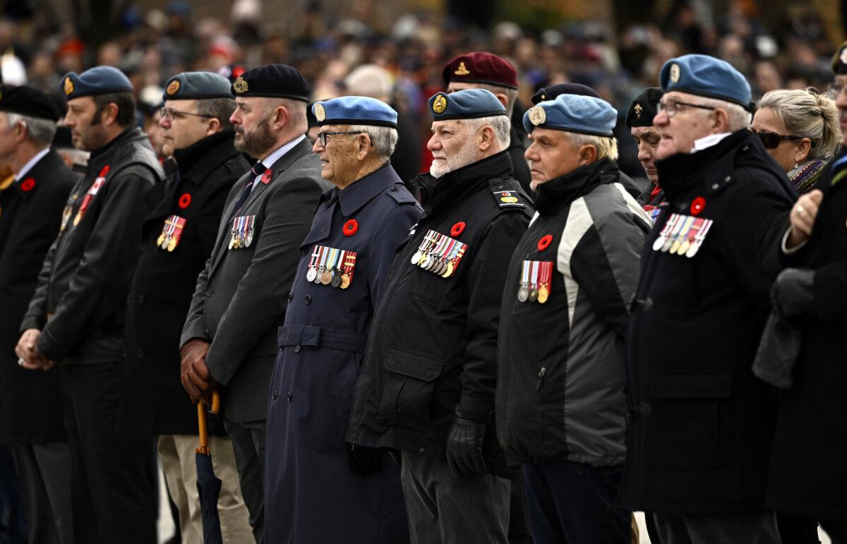 Veterans stand during the National Remembrance Day Ceremony at the National War Memorial in Ottawa on Nov. 11, 2023. (The Canadian Press/Justin Tang)