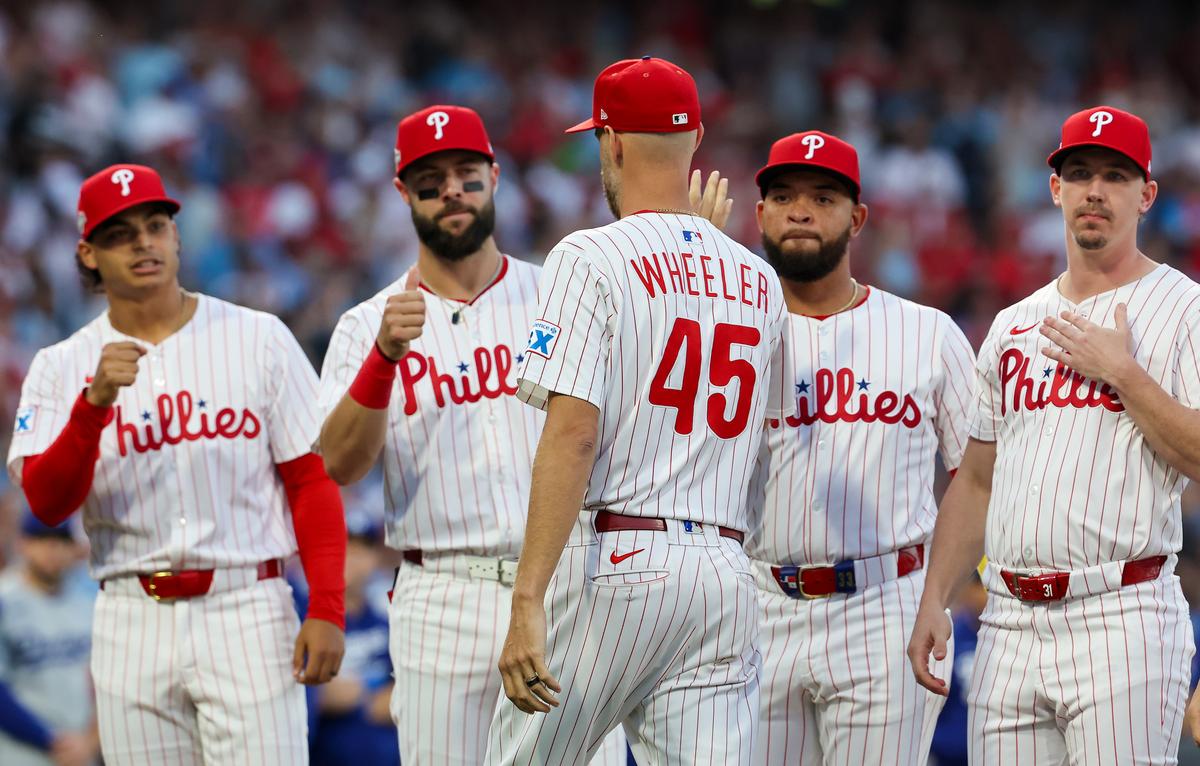 Zack Wheeler (45) of the Philadelphia Phillies is greeted by teammates before playing the Los Angeles Dodgers in game one of the Division Series at Citizens Bank Park in Philadelphia on Oct. 4, 2025. (Hunter Martin/Getty Images)