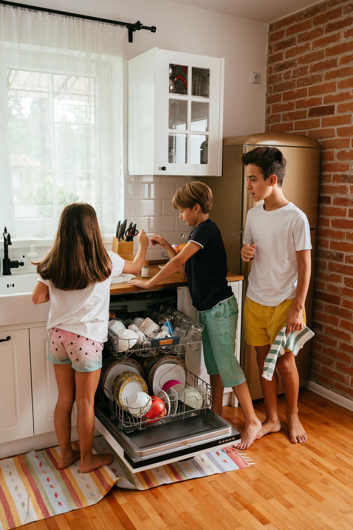 Pre-soaking dishes and loading the dishwasher by category speeds up the cleanup process. (MelkiNimages/Getty Images)