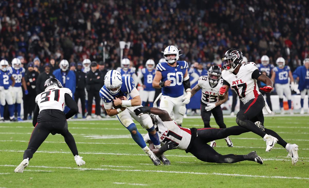 Daniel Jones of Indianapolis Colts is tackled by Jalon Walker of Atlanta Falcons during a 2025 game at Olympiastadion in Berlin on Nov. 09, 2025. (Boris Streubel/Getty Images)