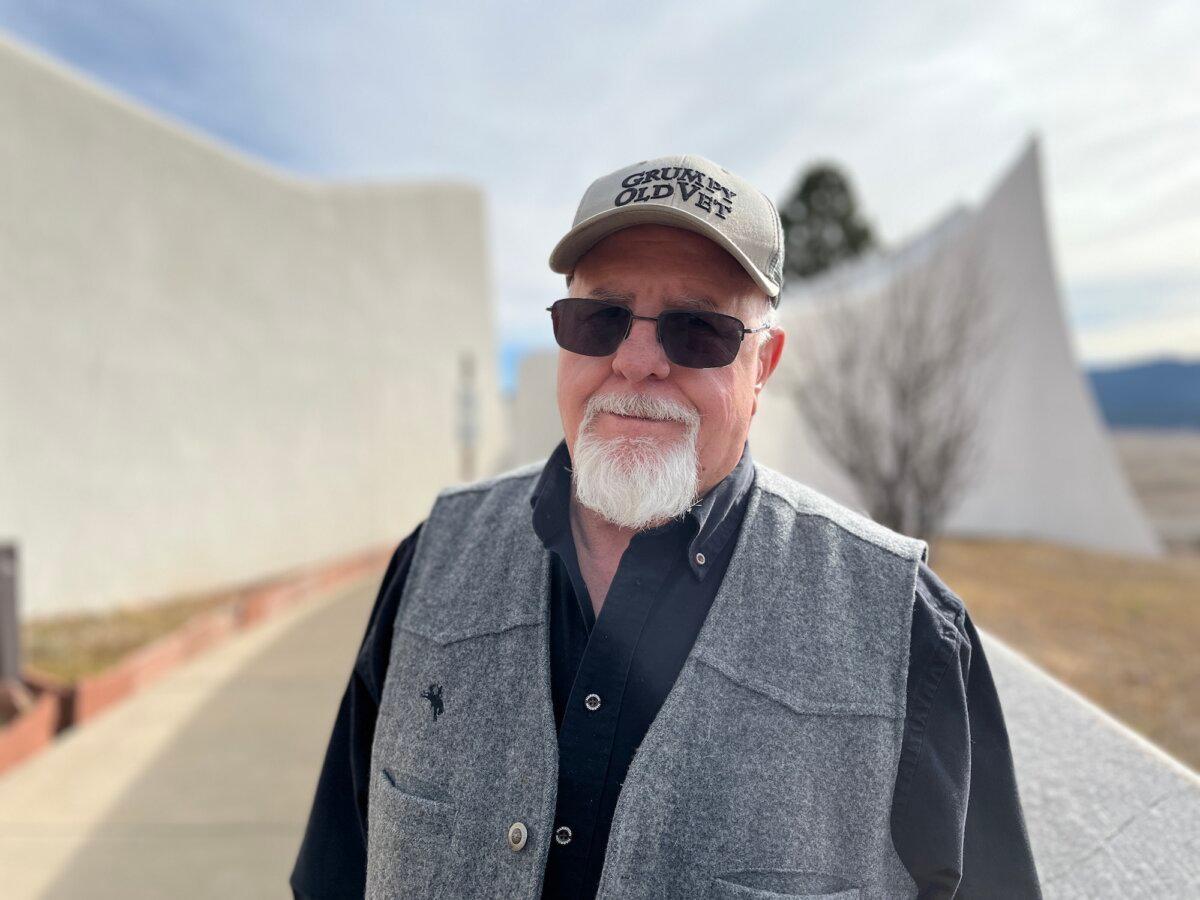 Vietnam Veterans Memorial staff member David Walker stands in front of the memorial chapel in Angel Fire, N.M., on Nov. 11, 2025. (Allan Stein/The Epoch Times)