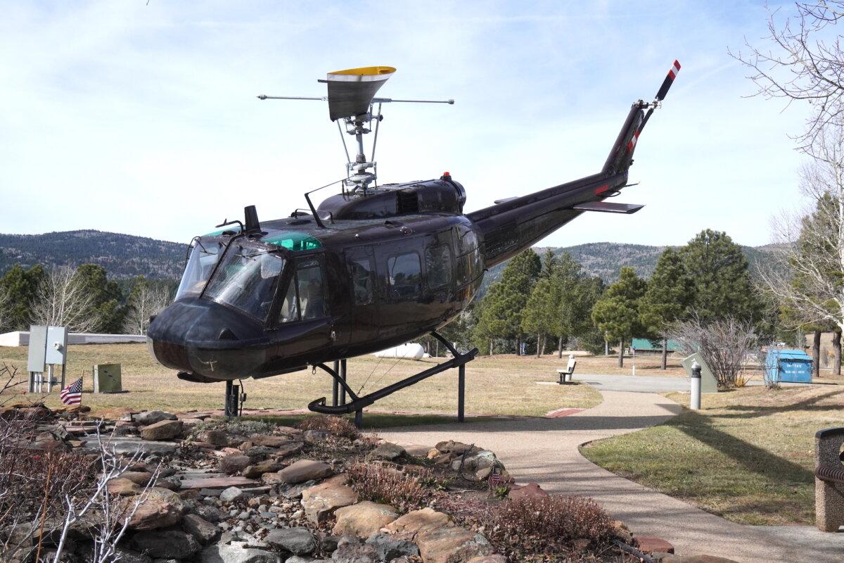 An actual helicopter smokeship used in Vietnam, known as a "Huey," sits on display outside the Vietnam Veterans Memorial in Angel Fire, N.M., on Nov. 11, 2025. (Allan Stein/The Epoch Times)