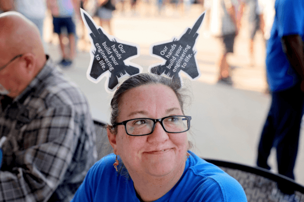 Christy Williams greets people at the voting check-in table, where International Association of Machinists and Aerospace Workers union members picked up their ballot to vote on a negotiated tentative labor agreement that would end their strike against Boeing Defense St. Louis regional operations. in Maryland Heights, Mo., on Sept. 12, 2025. (David Carson/St. Louis Post-Dispatch via AP)