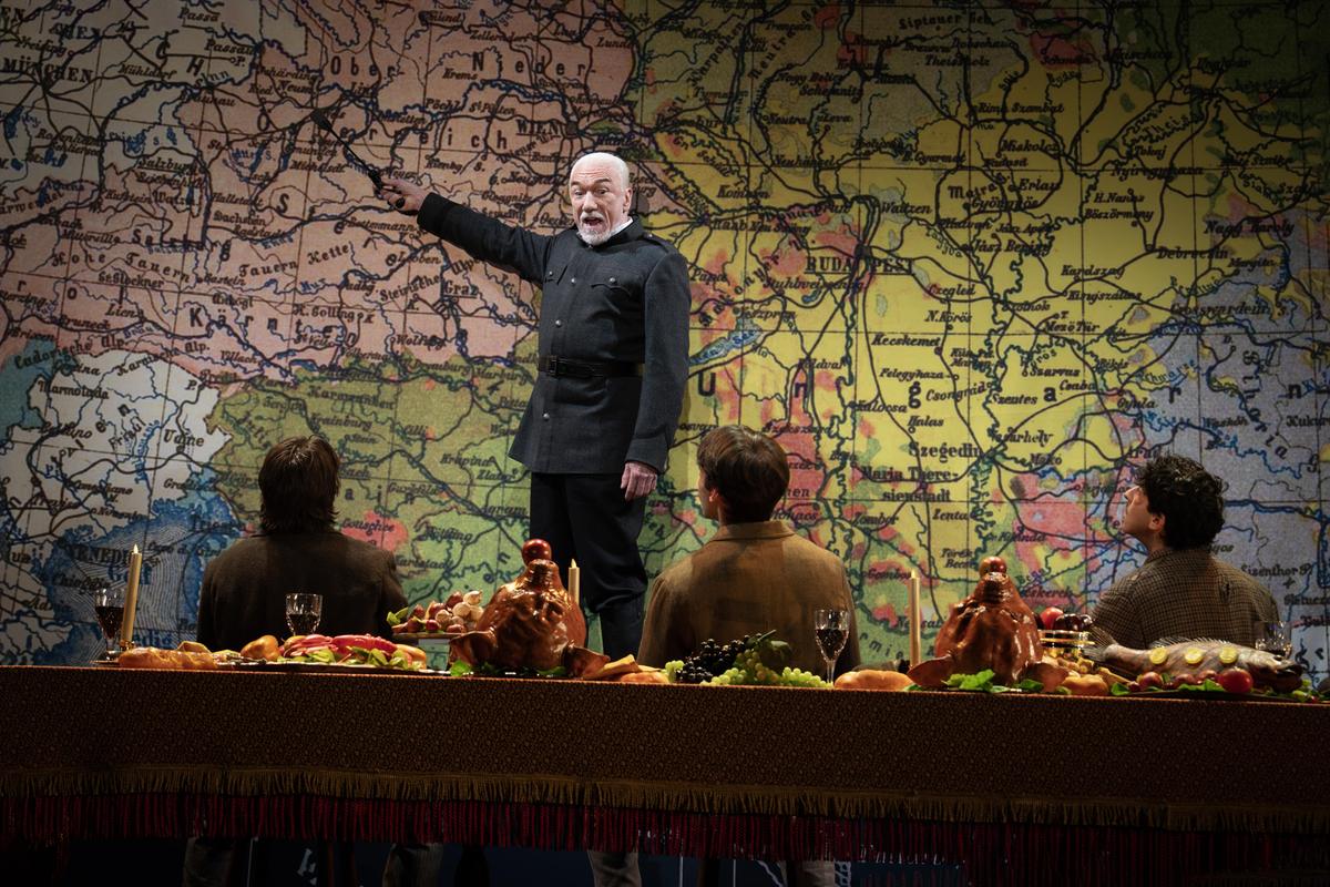 Dragutin “Apis” Dimitrijevic (Patrick Page) explains his plan to assassinate the Archduke Franz Ferdinand, in "Archduke." (Joan Marcus)