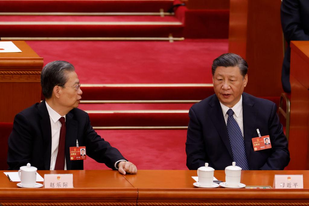 Chinese leader Xi Jinping speaks with National People’s Congress Chairman Zhao Leji during the fifth plenary session of the National People’s Congress, China’s rubber-stamp legislature, in Beijing on March 12, 2023. (Lintao Zhang/Getty Images)