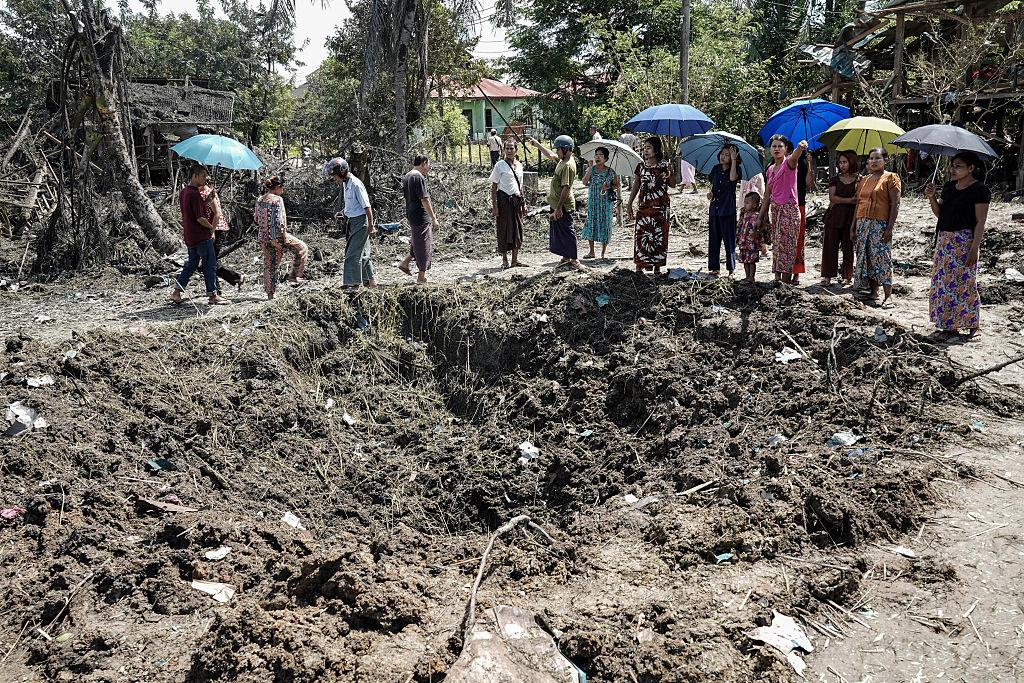 People inspect the damage after bombardments carried out by Myanmar's military in Mrauk U, Myanmar's Rakhine State, on Aug. 26, 2025. A Myanmar junta air strike on a rebel-held town in the country's hunger-ravaged west killed at least 12 people, witnesses of the overnight bombing said on Aug. 26. (STR/AFP via Getty Images)