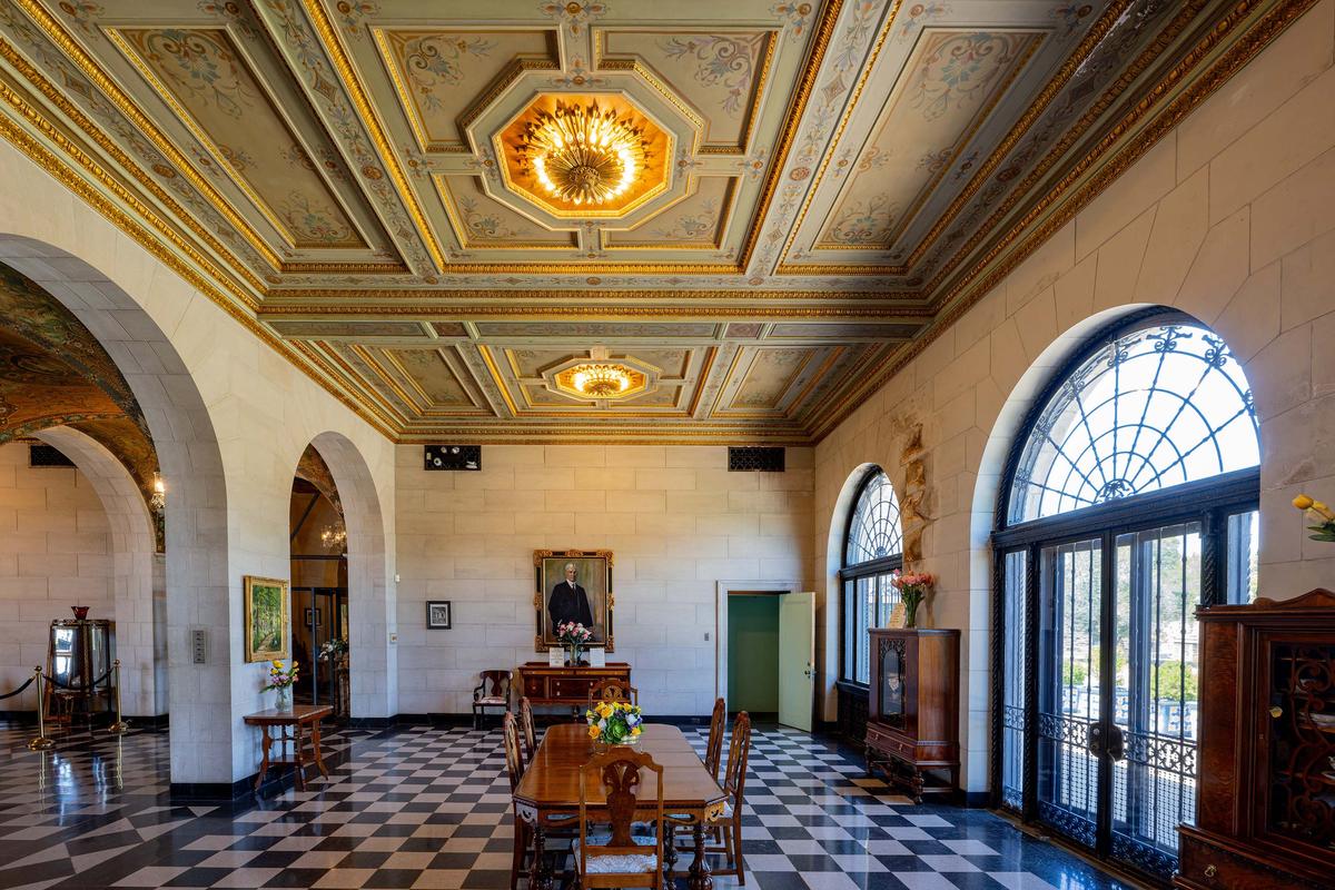 Flanking the loggia are the North Salon and South Salon, where E.W. Marland and Lydie Marland welcomed guests for formal events. The North Salon (pictured here) was also called the Sun Room and features Italian stucco walls and a gold-trimmed coffered ceiling that was richly painted by Vincent Maragliotti. (Kit Leong/Shutterstock)