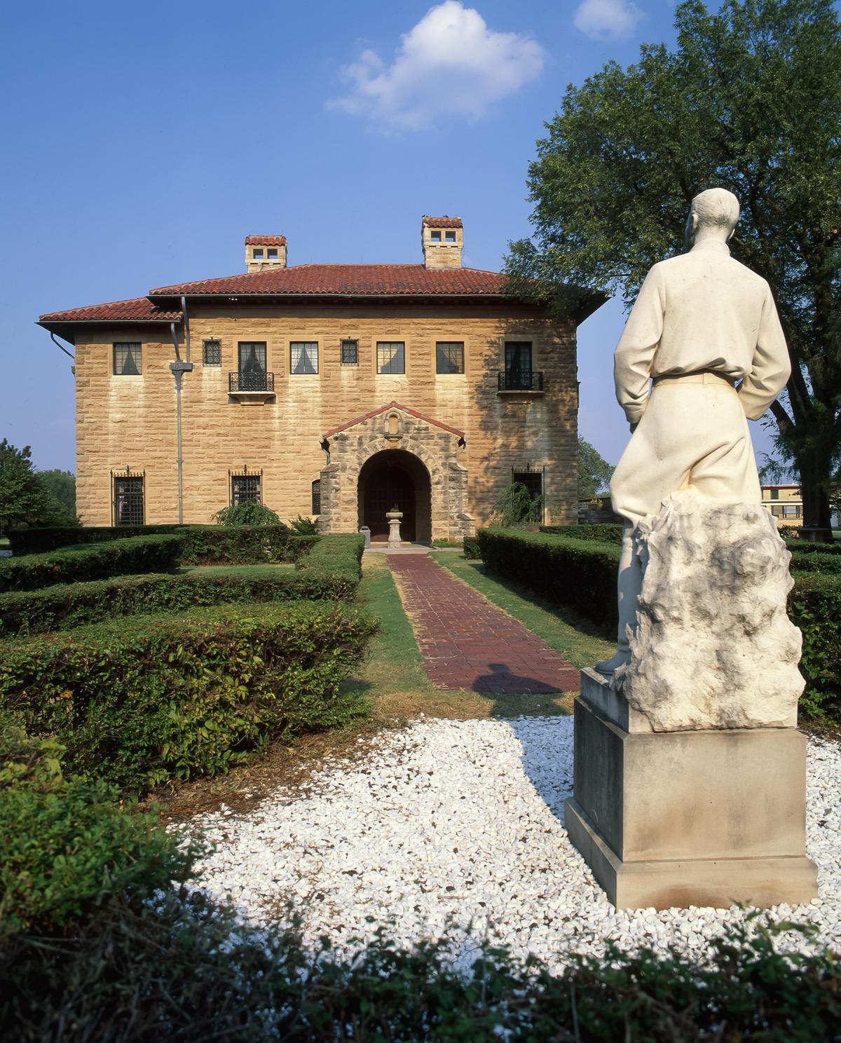 A replica statue of George Roberts (E.W. Marland's adopted son) stands in the garden facing the mansion's western entrance. It is one of three French limestone statues that Marland commissioned from sculptor Jo Davidson for his mansion. The original works by Davidson now stand just inside the entrance to the house. (Richard G Smith/Shutterstock)