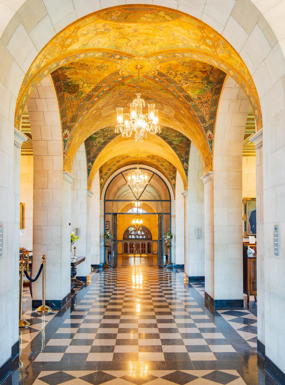 The loggia features an intricately painted ceiling mural by Vincent Maragliotti. The design is inspired by Chinese Chippendale motifs, which incorporated Gothic and Asian elements. Painted by Maragliotti on flat sheets of canvas, the mural was then applied to the curved plaster vaults. The checkered floor is terrazzo, which is a mixture of crushed marble and concrete poured into brass dividers. (Kit Leong/Shutterstock)