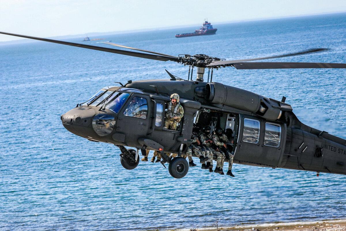 Special operations forces from Trinidad and Tobago and Jamaica aboard a UH-60 Black Hawk helicopter assigned to Alpha Company, 1st Battalion, 169th Aviation Regiment, New Hampshire Army National Guard, conduct an air assault during an exercise on May 7, 2025. (U.S. Army National Guard photo by Sgt. Timicia GeorgePetrus)