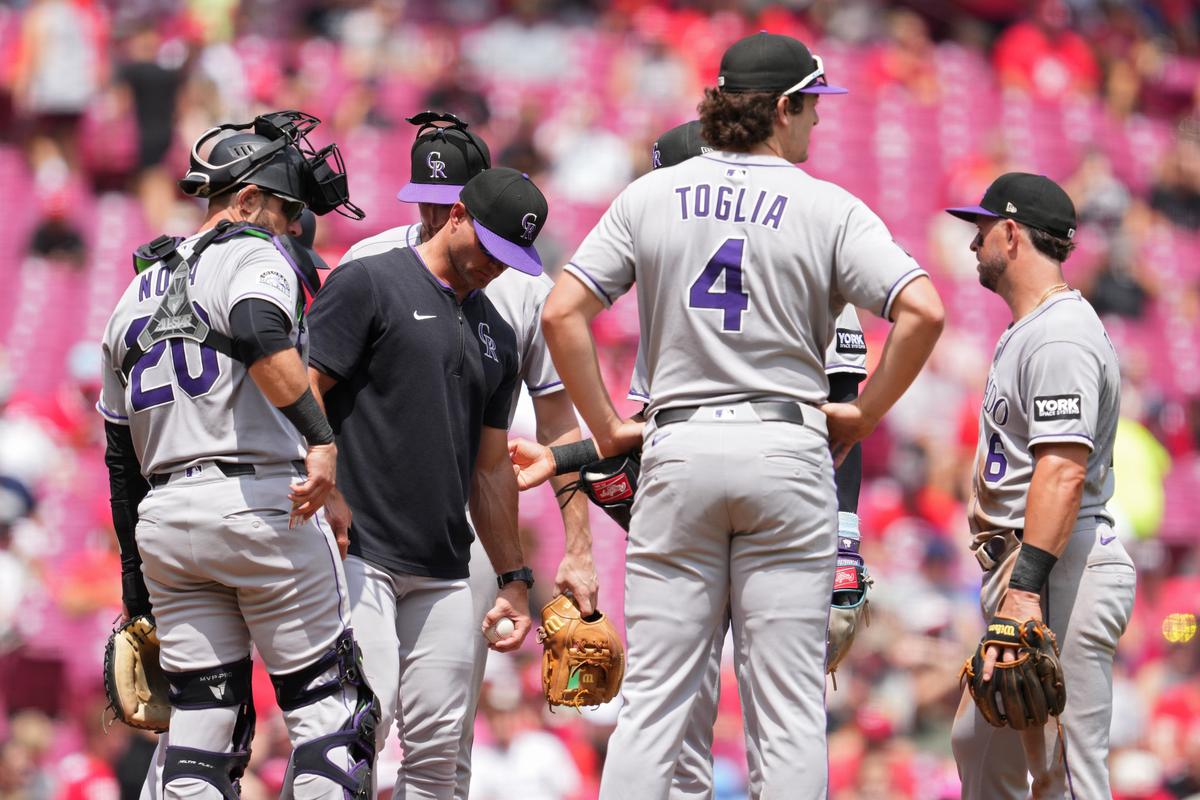 Warren Schaeffer of the Colorado Rockies gathers with his team at the pitcher’s mound during a pitching change in the fifth inning of a baseball game at Great American Ball Park in Cincinnati on July 13, 2025. (Jeff Dean/Getty Images)