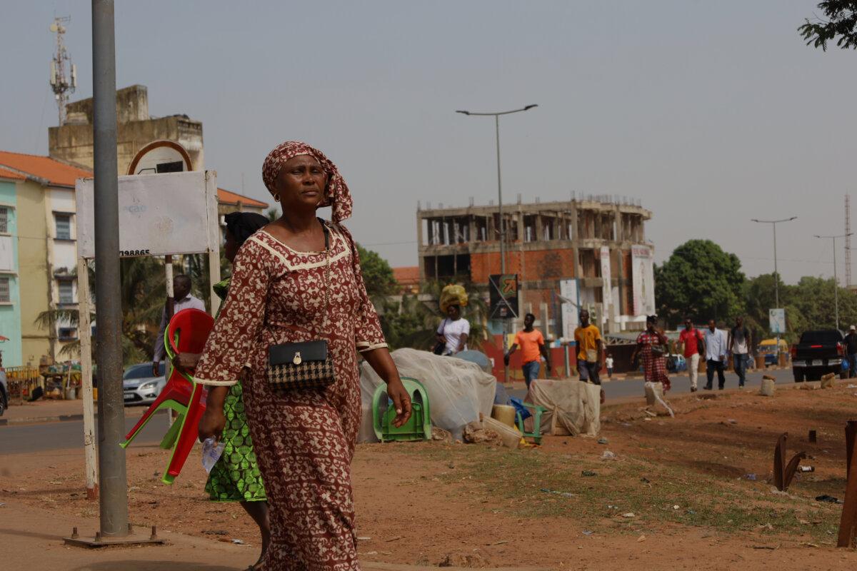 People walk on the street in Bissau, Guinea-Bissau, on Nov. 26, 2025. (Darcicio Barbosa/AP Photo)