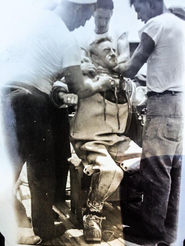 Ken Hartle suiting up for a dive. (Public Domain)