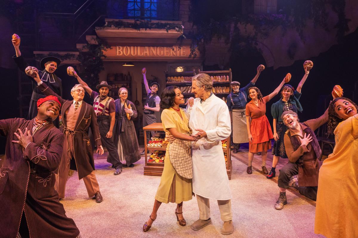 Geneviève Castagnet (Ariana DeBose) and her husband Aimable (Scott Bakula) are surrounded by the French villagers, in "The Baker's Wife." (Matthew Murphy and Evan Zimmerman)