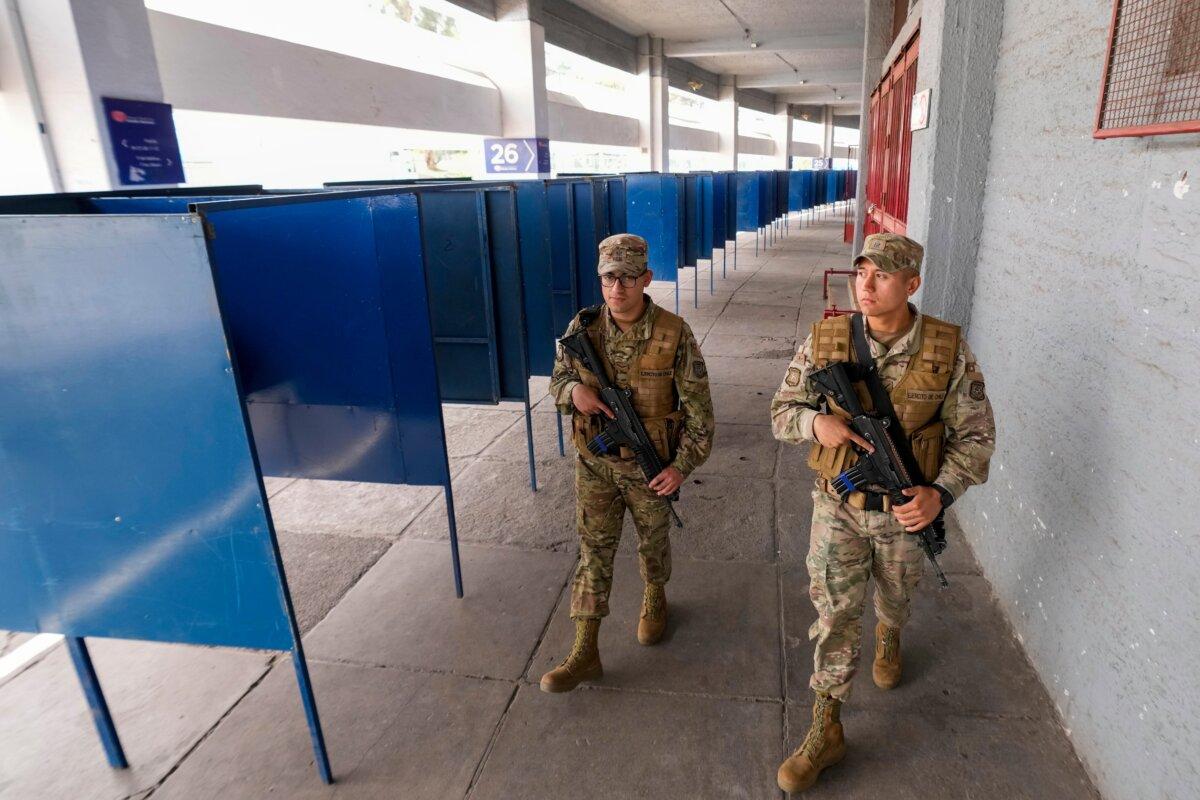 Soldiers patrol the National Stadium, which was used as a polling station during Sunday's general elections, in Santiago, Chile, Saturday, Nov. 15, 2025. (AP Photo/Esteban Felix)