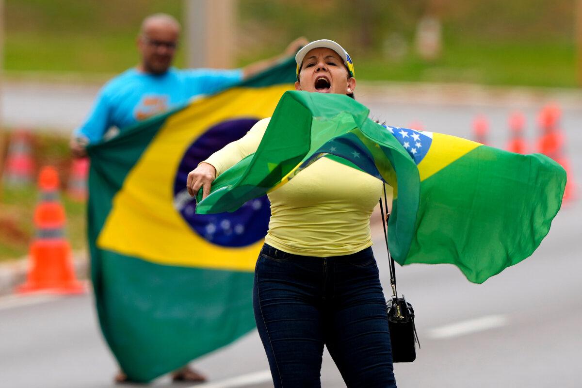 Supporters of former President Jair Bolsonaro protest outside the federal police headquarters, where he is being held, in Brasilia, Brazil, on Nov. 23, 2025. (Eraldo Peres /AP Photo)