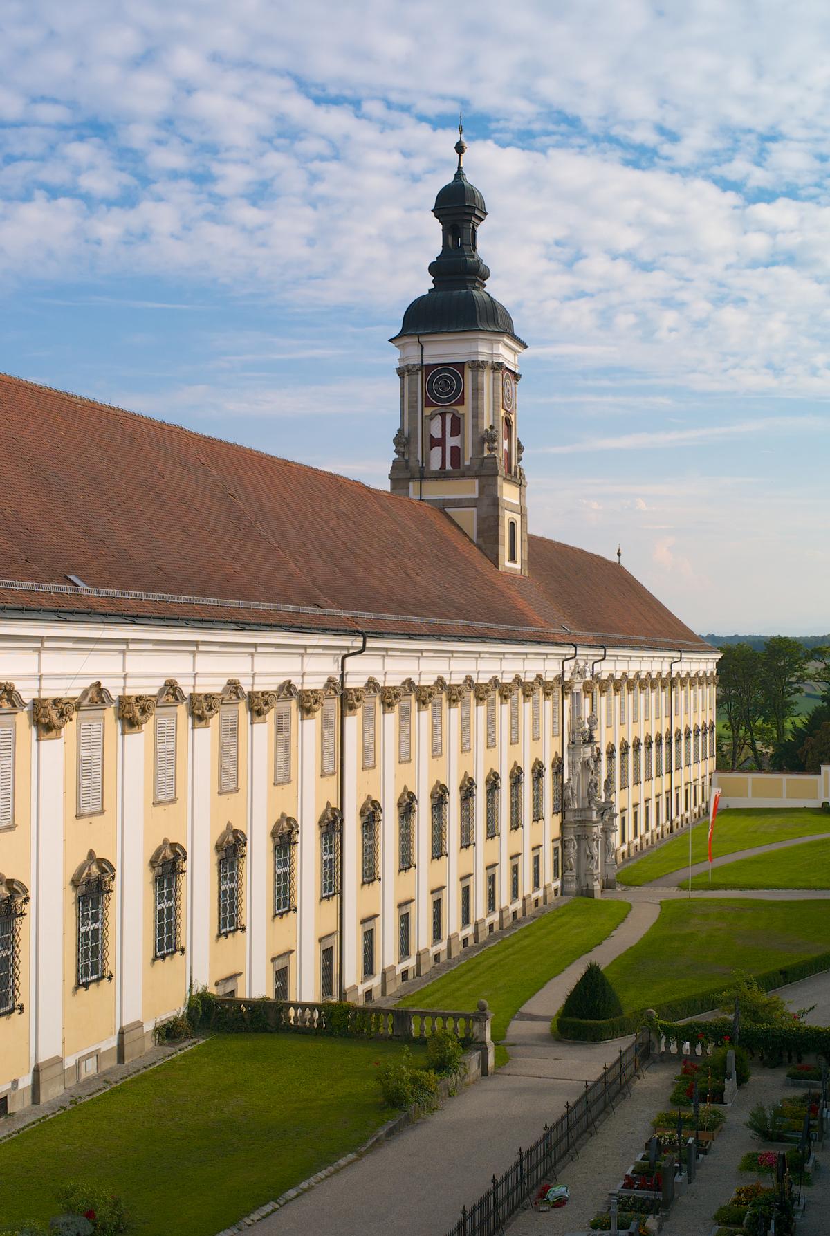 The tireless symmetry of a multitude of vertical windows is evident in the three stories at St. Florian Monastery. Although the ground-floor windows are covered in a simple pediment, the second- and third-floor windows feature more decorative pediments. Separating each three-story section of windows is a column facade topped with a highly ornamented, carved capital. (Dietmar Rauscher/Shutterstock)