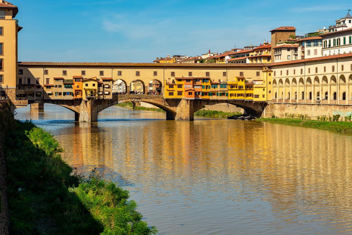 The Ponte Vecchio (Old Bridge) crosses the Arno River in Florence, Italy. It consists of three segmental arches with closed spandrels, which are the two triangles that create the top of each arch. The largest, middle arch spans about 98 feet wide, and the side arches span about 89 feet wide. The Vasari Corridor (R) runs from the Palazzo Vecchio (the Town Hall) via the Uffizi Gallery, across the Ponte Vecchio to the Palazzo Pitti. (Mistervlad/Shutterstock)