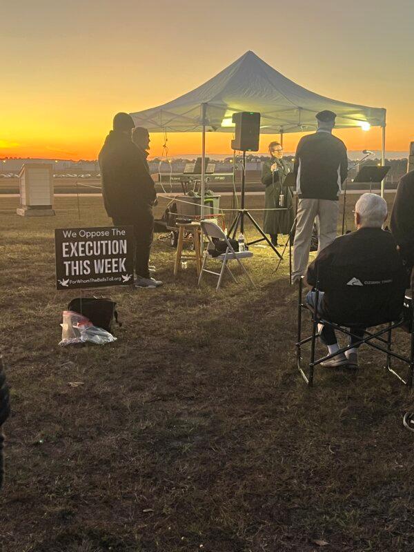 Signs and posters are set up outside Florida State Prison in Raiford, Fla., on Dec. 9, 2025, as the execution of Mark Geralds brought the state total to 18. The sign reads "We oppose the execution this week." (Troy Myers/The Epoch Times)