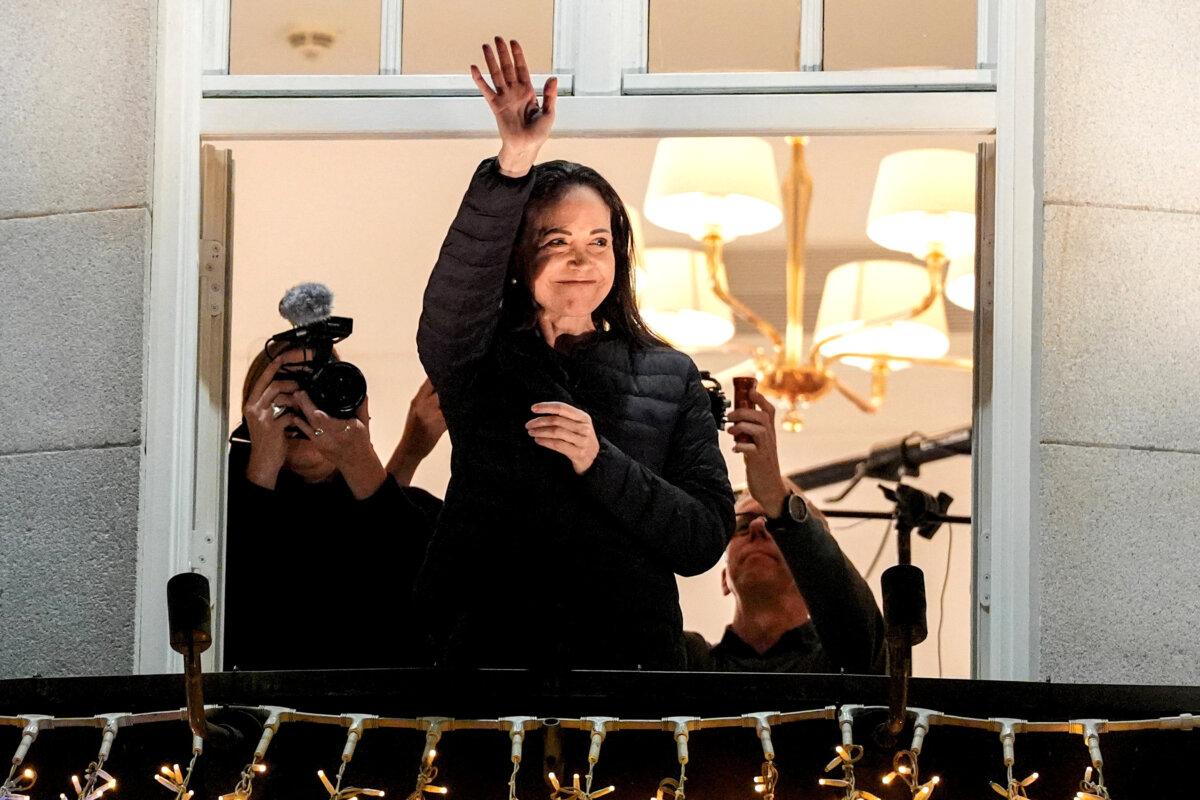 Nobel Peace Prize laureate María Corina Machado waves from the balcony at the Grand Hotel in Oslo, Norway, on Dec. 11, 2025. (Lise Aserud/NTB via Reuters)