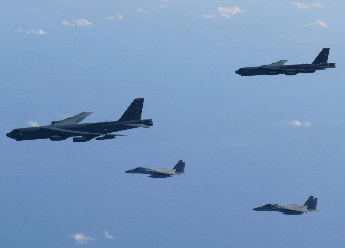 The 6th Air Wing of Japan Air Self-Defense Force's F-15 fighters hold a joint military drill with the U.S. B-52 bombers over the Sea of Japan on Dec. 10, 2025. (Joint Staff Office of the Defense Ministry of Japan/Handout via Reuters)