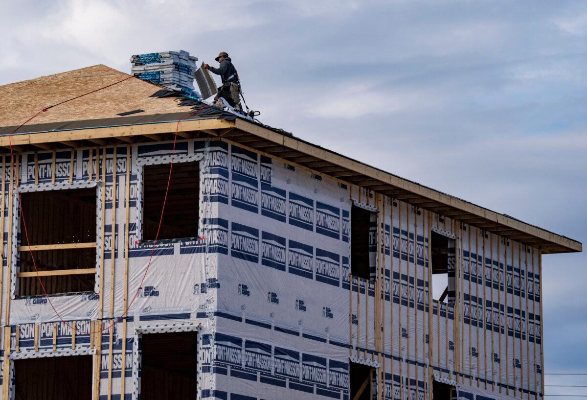 A roofer works on a new housing development in Salaberry-de-Valleyfield, Que., southwest of Montreal, on Oct. 22, 2025. (The Canadian Press/Christinne Muschi)