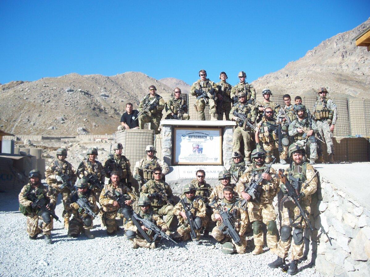 Members of the U.S. Army's 10th Special Forces Group, including Corey Terry, and their interpreter Sammy Nemat, pose for a photo alongside Romanian troops at Forward Operating Base Kutschbach in the Kapisa Province of Afghanistan in 2008. (Courtesy of Corey Terry)