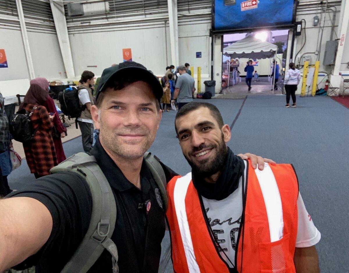 Corey Terry and Sammy Nemat pose for a photo together at Holt Logistics Corp.'s Pier 5 terminal in Camden, N.J., where they assisted with processing Afghan evacuees, on Sept. 7, 2021. (Courtesy of Corey Terry)
