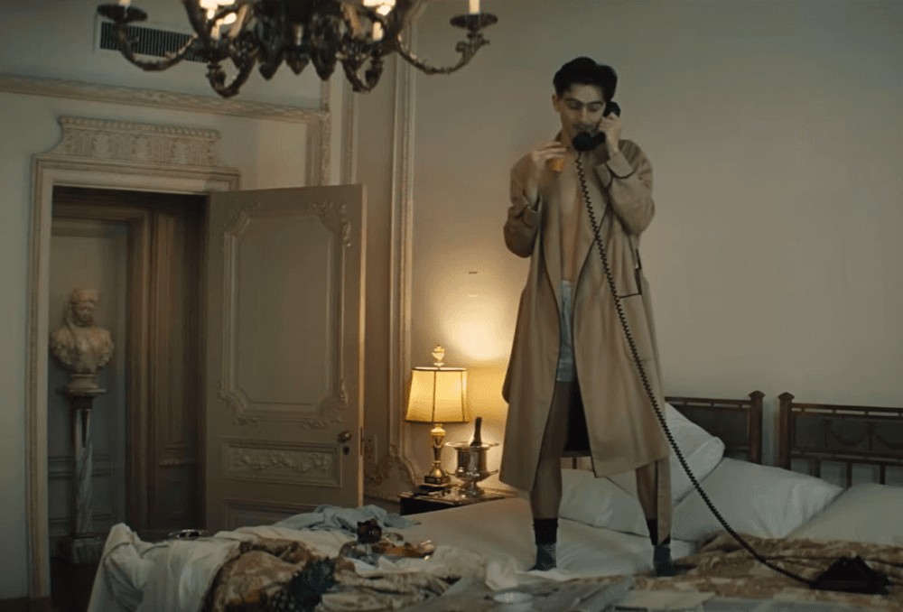 Marty Mauser (Timothée Chalamet) in a hotel room he's not supposed to be in, in "Marty Supreme." (A24)