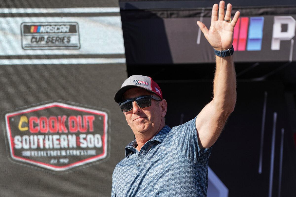 Former driver Greg Biffle waves to fans prior to a NASCAR Cup Series auto race at Darlington Raceway in Darlington, S.C., on Aug. 31, 2025. (Matt Kelley/AP Photo)