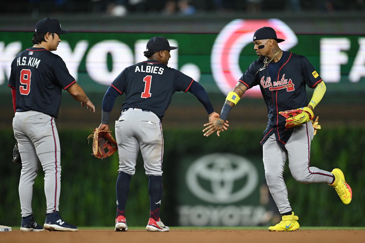 Ha-seong Kim (9), Ozzie Albies (1), and Ronald Acuna Jr. (13) of the Atlanta Braves celebrate after the game against the Chicago Cubs at Wrigley Field in Chicago on Sept. 3, 2025. (Daniel Bartel/Getty Images)