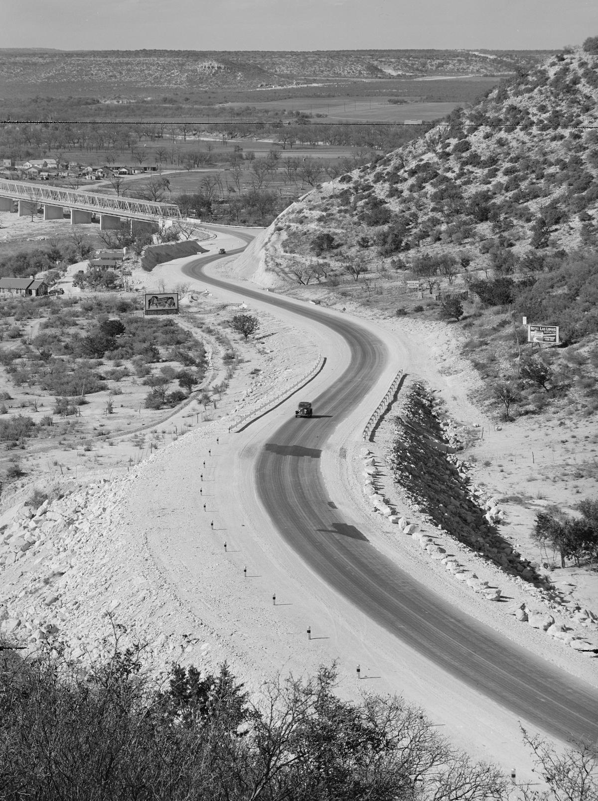 Highway leading into Junction, Texas, which was West Texas's center for raising livestock, 1940, by Russell Lee. Terry Stafford's "Amarillo by Morning" was partly inspired by his seven-and-a-half-hour road trip from San Antonio to Amarillo, Texas. Library of Congress. (Public Domain)