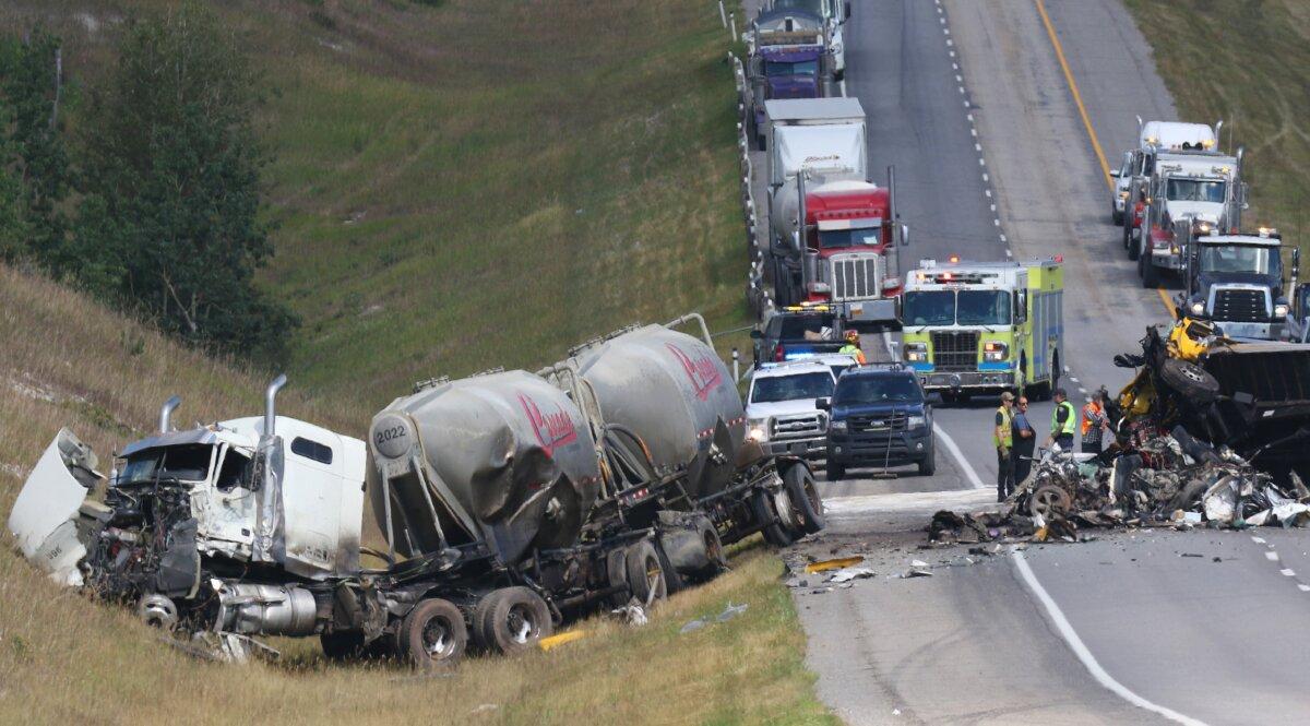 Police and emergency workers attend the scene of a fatal collision on the Trans Canada Highway near Morley, Alta., west of Calgary, on Aug. 11, 2021. (The Canadian Press/Dave Chidley)
