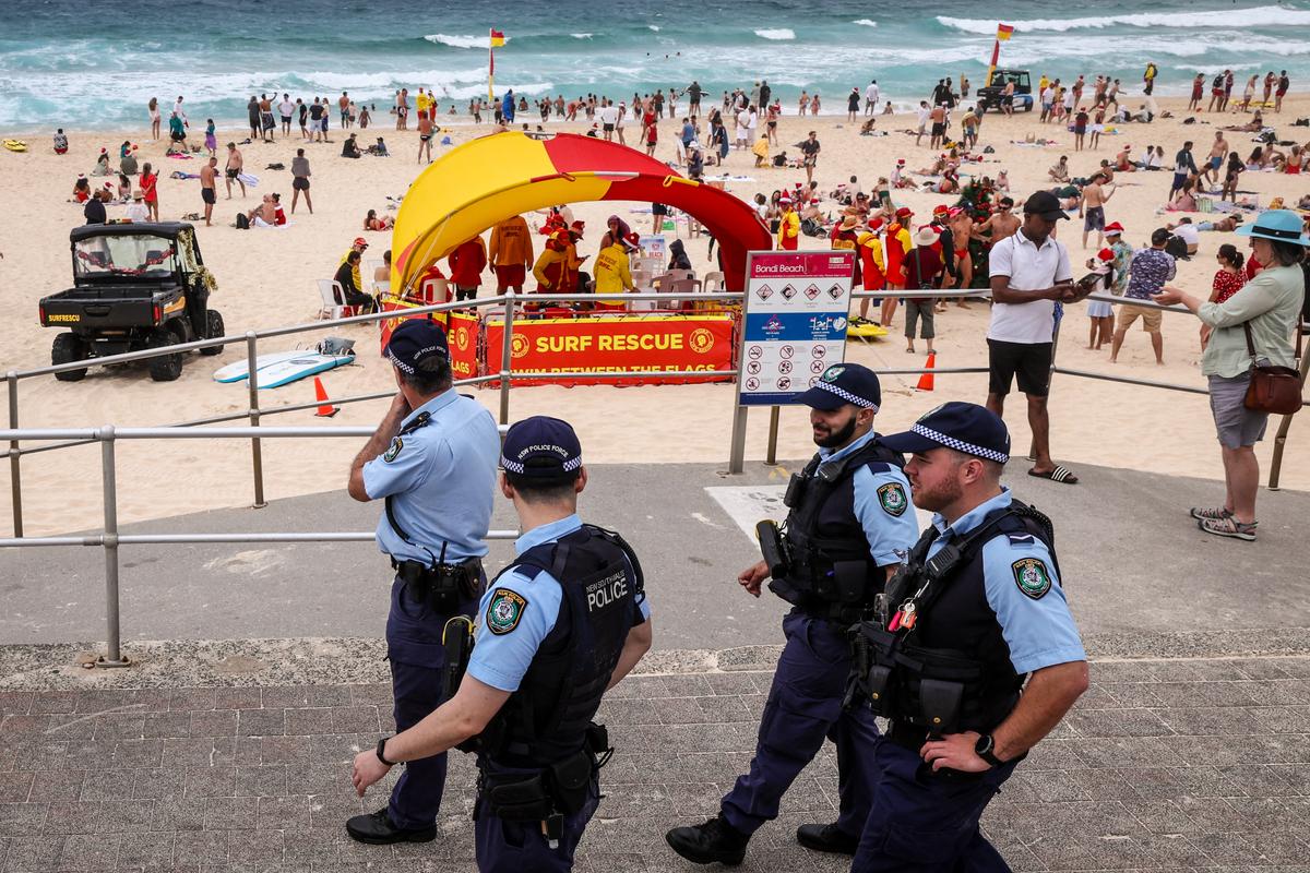 Police officers patrol near beachgoers on Christmas Day at Bondi Beach in Sydney, Australia on Dec. 25, 2025. (David Gray/ AFP via Getty Images)