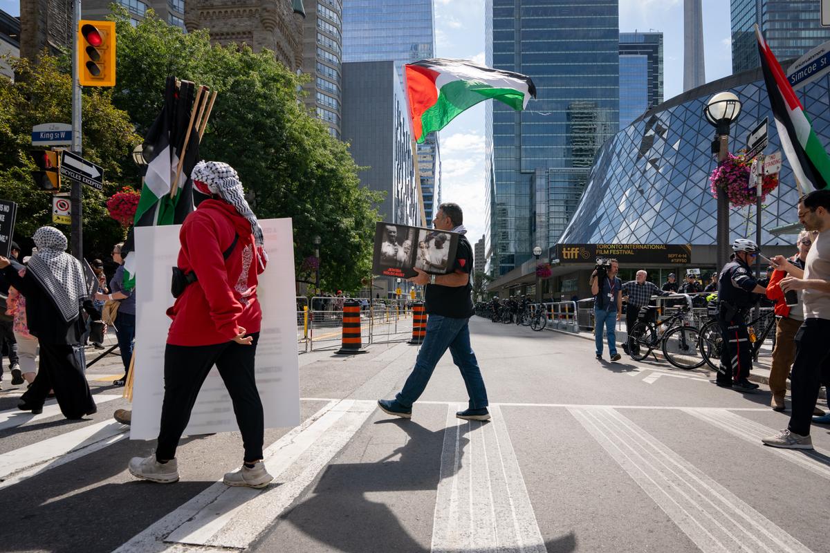 Pro-Palestinian protesters gather outside of Roy Thomson Hall during Toronto International Film Festival in Toronto on Sept. 10, 2025. (The Canadian Press/Arlyn McAdorey)