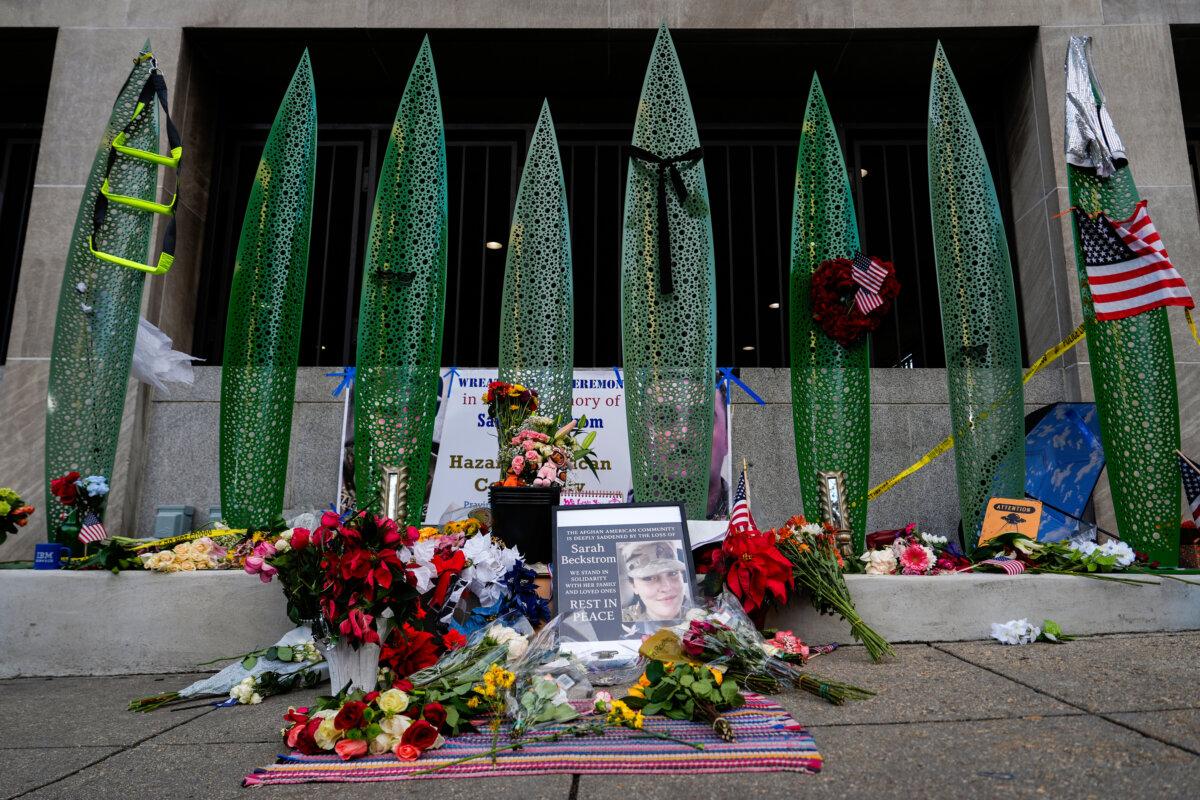 A makeshift memorial for U.S. Army Spc. Sarah Beckstrom and U.S. Air Force Staff Sgt. Andrew Wolfe outside of Farragut West Station, near the site where the two National Guard members were shot, in Washington on Dec. 1, 2025. (Julia Demaree Nikhinson/AP Photo)