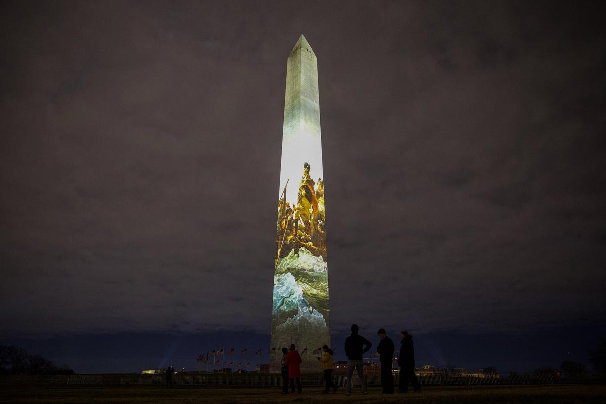 The Washington Monument is illuminated with a projection of President Donald Trump's "Freedom 250" initiative during the New Year's Eve show at the National Mall in Washington on Dec. 31, 2025. (Amid FARAHI/AFP via Getty Images)