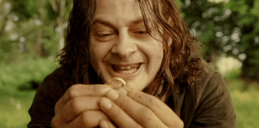 Proto-hobbit Smeagol (Andy Serkis) holding the One Ring, which he strangled his friend Deagol to possess, in "The Lord of the Rings: The Return of the King." (New Line Cinema)