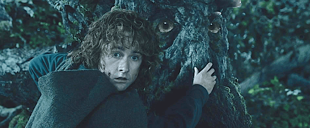Peregrin Took, otherwise known as Pippen (Billy Boyd) hangs onto the ent Treebeard's nose (John Rhys-Davies), in "The Lord of the Rings: The Two Towers." (New Line Cinema)